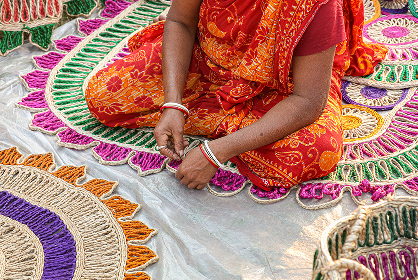 Woman crocheting a colorful mat