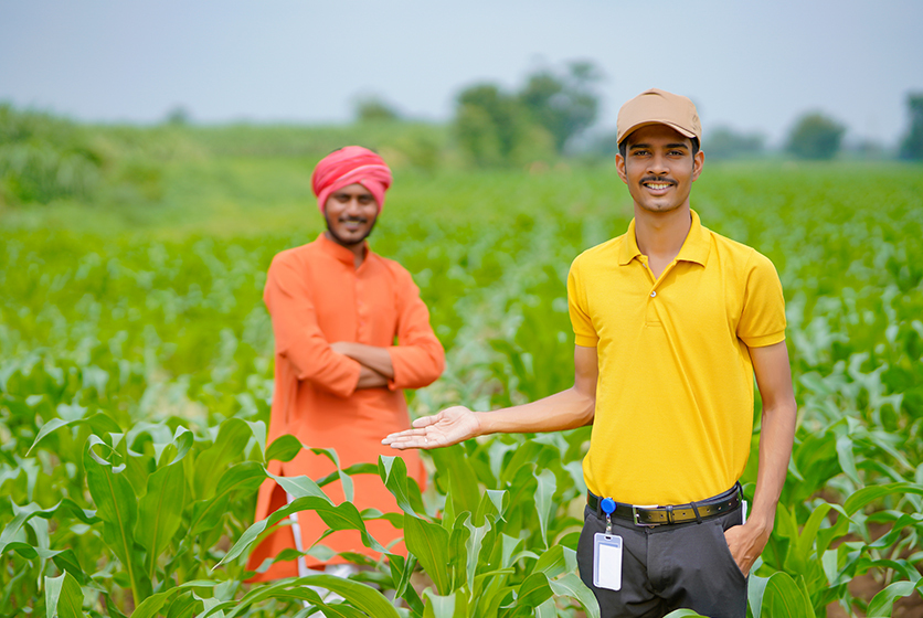 Youth with farmer in a field