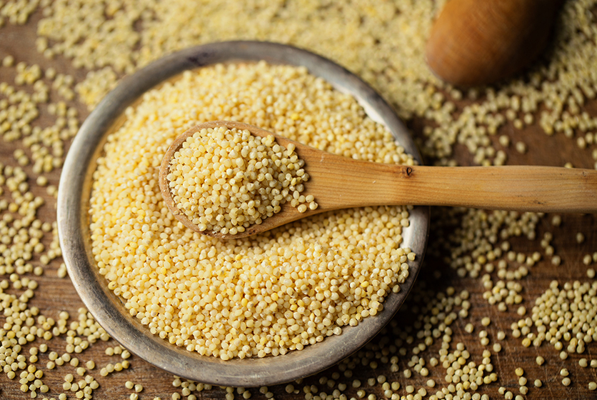 A bowl and spoonful of millets