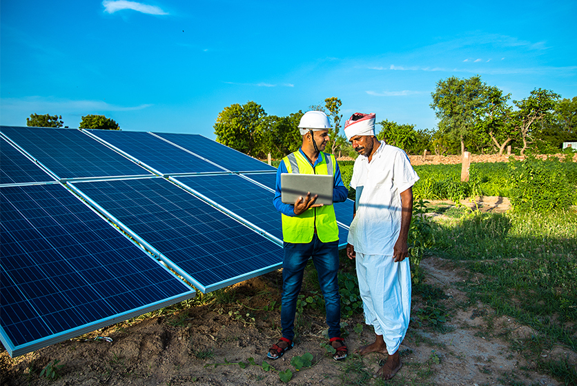 Engineer explaining solar power to a farmer