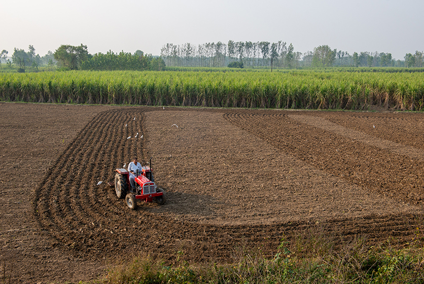 Farmer on a tractor ploughing a land