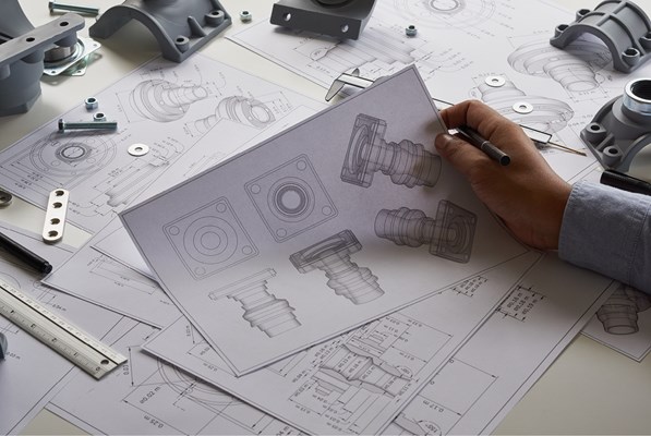 Hand holding mechanical drawing