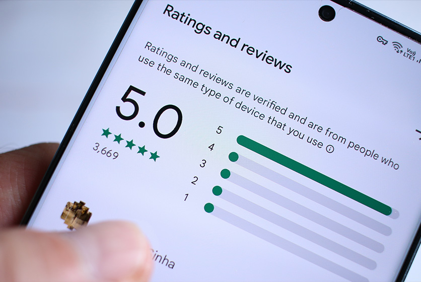 Hand holding a tablet showing excellent rating and reviews
