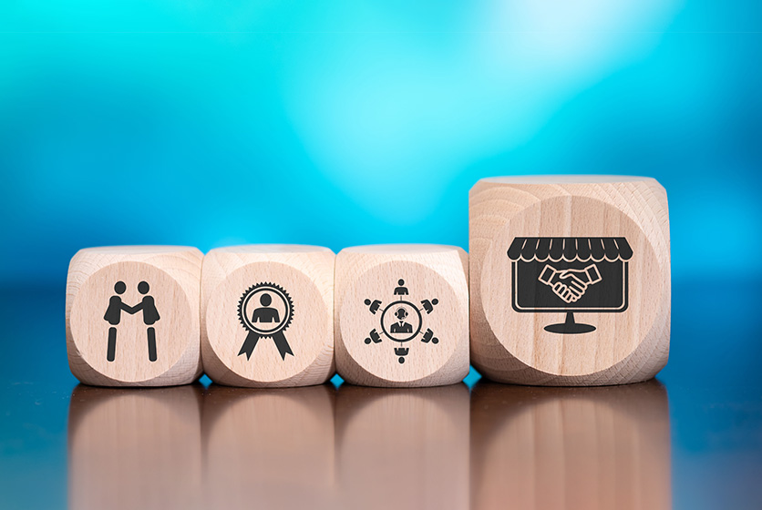 Wooden blocks showing symbols of customer, loyalty, and concept