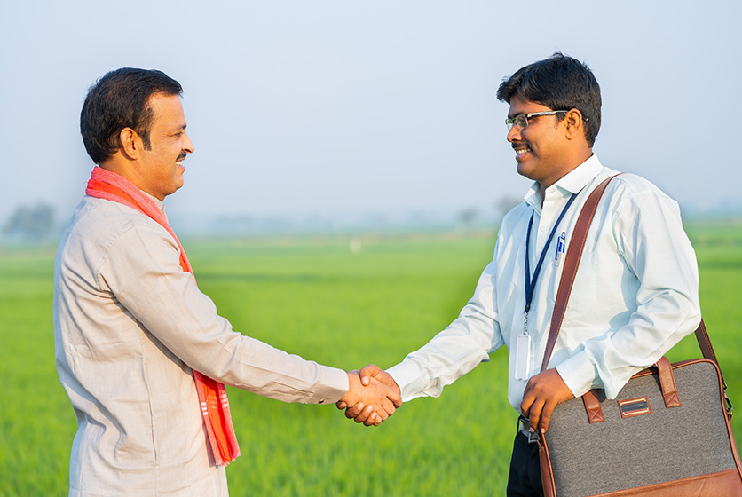 Executive shaking hands with a farmer