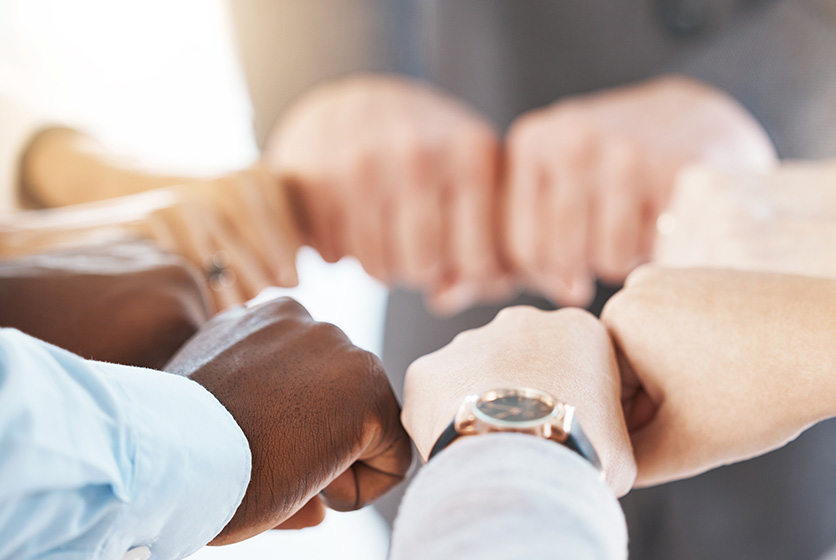 Business people doing a fist bump signifying teamwork