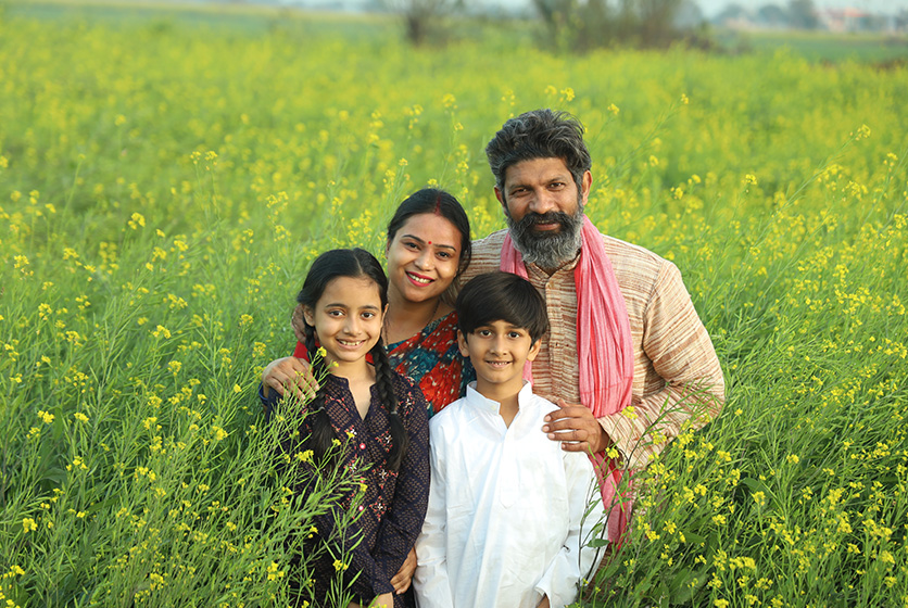 Happy farmer family in  a green field