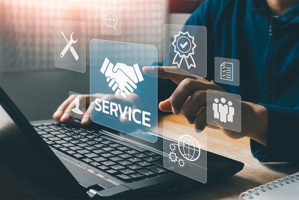 Technical support operator with virtual screen icons working on laptop computer