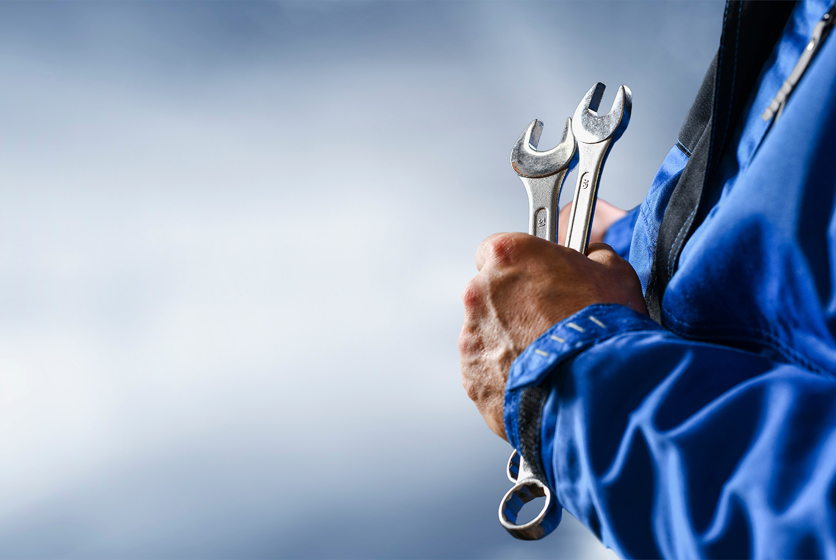 Mechanic working in warehouse and holding tools