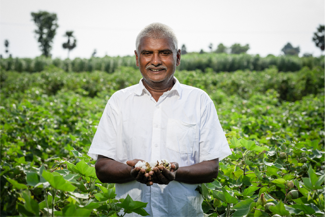 Happy farmer holding harvested crop in both palms
